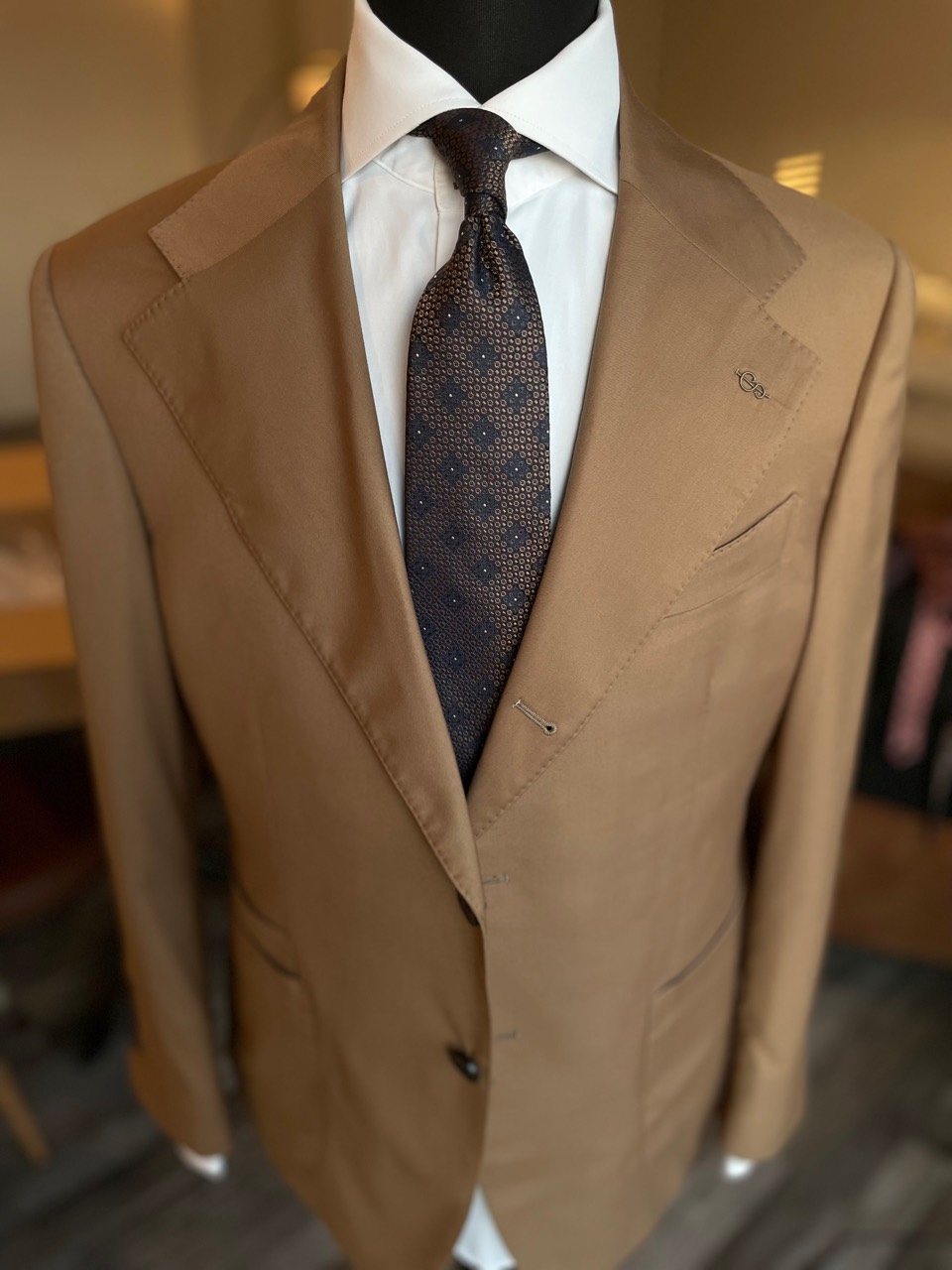 Tan custom suit with patterned tie