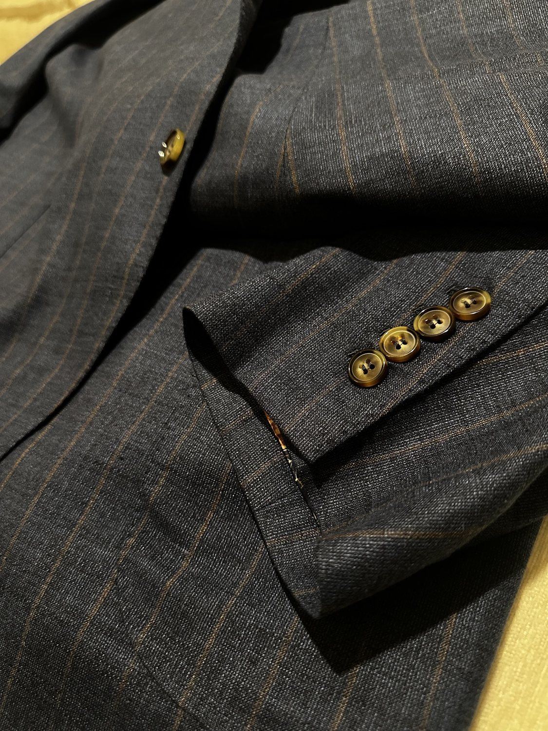 Dark windowpane suit sleeve and button detail