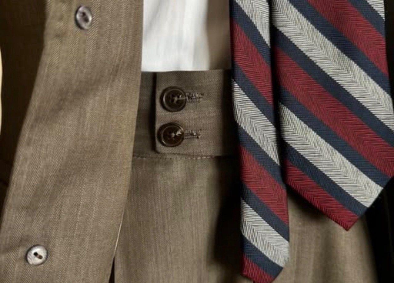 Tan vest and striped tie detail