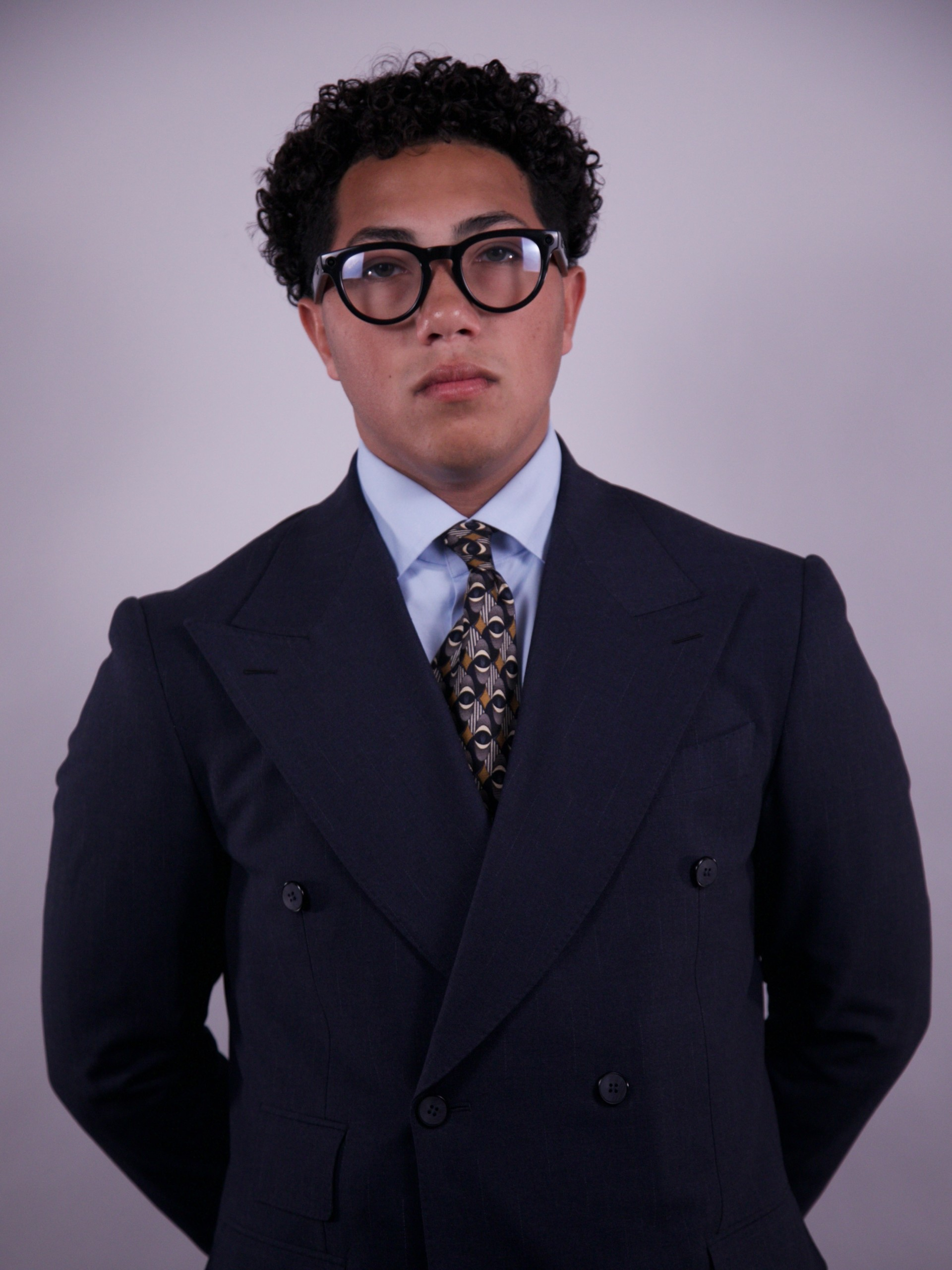 Elden Niemeyer wearing glasses and a tailored navy suit