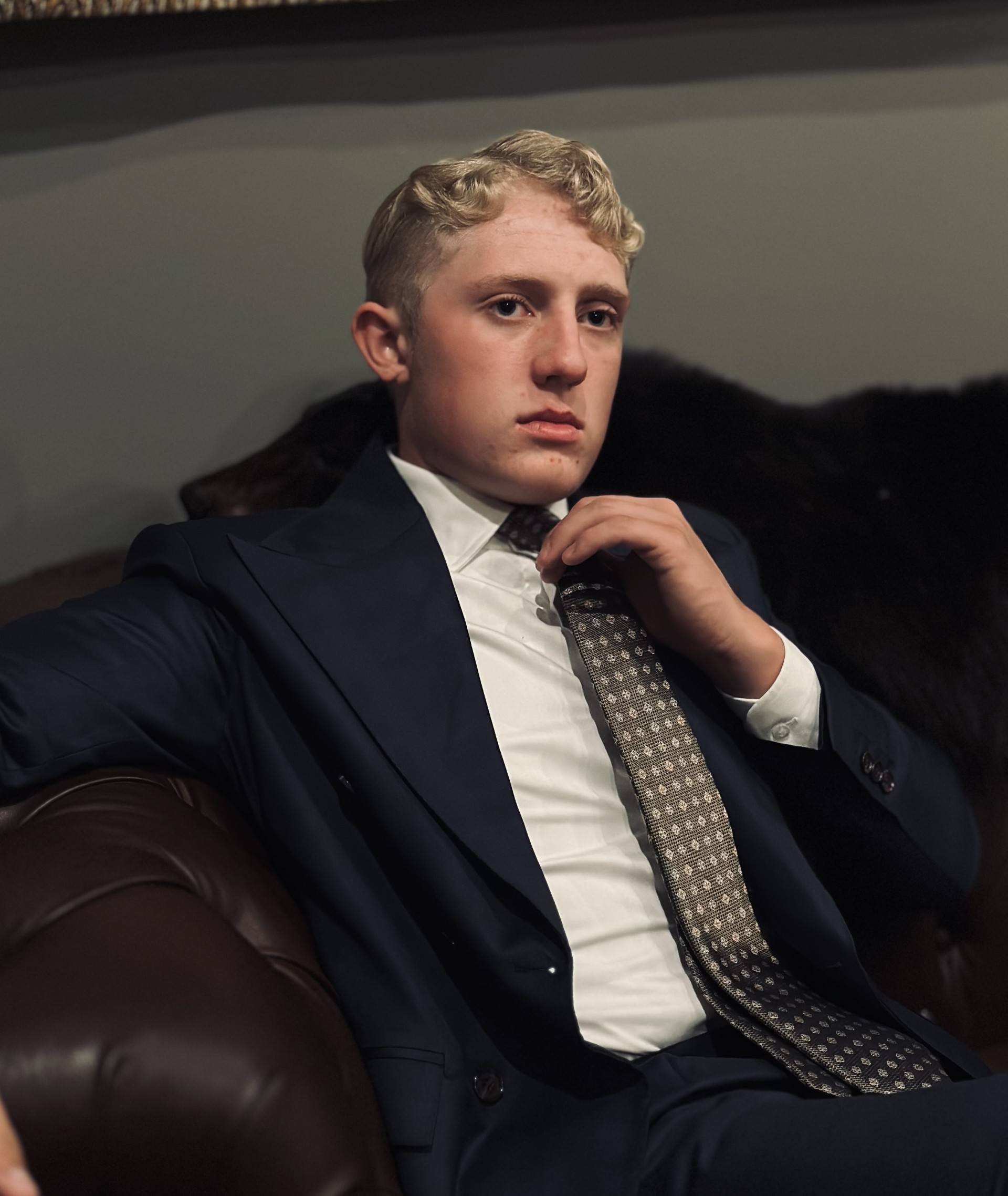 Peydon Domerese wearing a navy suit and patterned tie